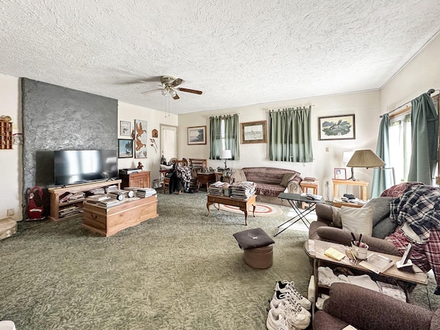 carpeted living room with a ceiling fan and a textured ceiling