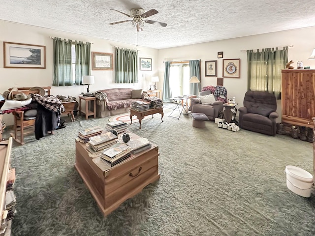 carpeted living area with a textured ceiling and ceiling fan