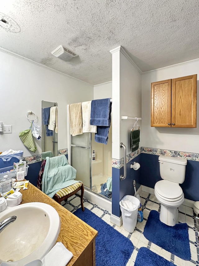 full bath with visible vents, toilet, a stall shower, a sink, and a textured ceiling