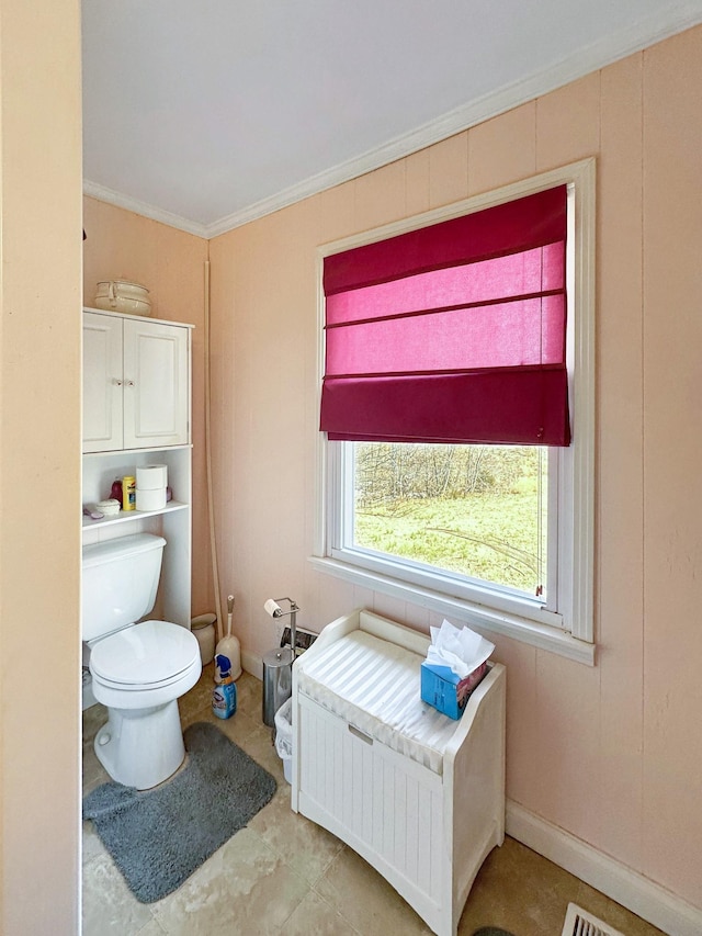 bathroom featuring toilet, baseboards, and ornamental molding