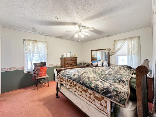 bedroom with carpet flooring, a textured ceiling, and ceiling fan