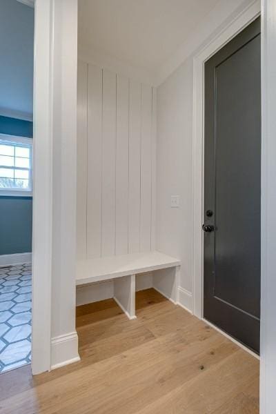 mudroom featuring wood finished floors and baseboards