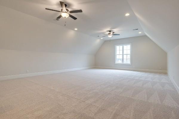 additional living space featuring recessed lighting, baseboards, light colored carpet, ceiling fan, and vaulted ceiling