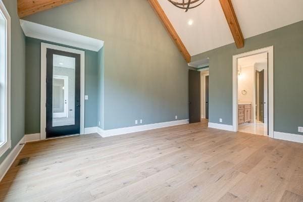 interior space featuring beamed ceiling, baseboards, high vaulted ceiling, and light wood finished floors