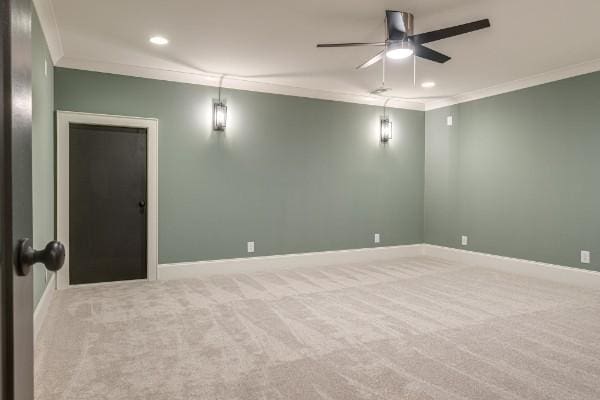 spare room featuring recessed lighting, crown molding, baseboards, and carpet floors