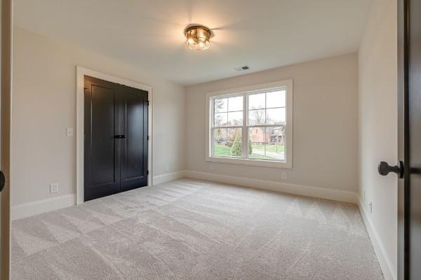 unfurnished bedroom with visible vents, baseboards, and carpet flooring