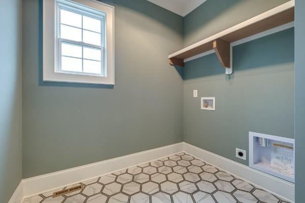 laundry area featuring baseboards, hookup for an electric dryer, laundry area, washer hookup, and tile patterned floors