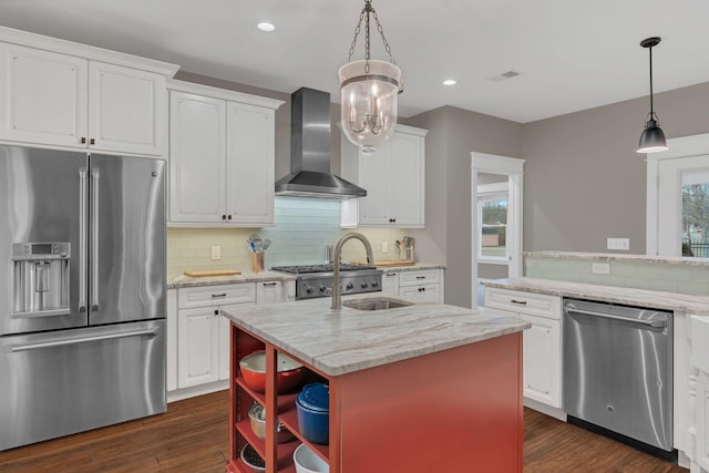 kitchen with dark wood-style floors, appliances with stainless steel finishes, wall chimney exhaust hood, and white cabinets