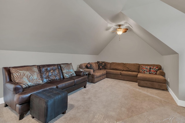 living area with baseboards, a ceiling fan, lofted ceiling, and carpet