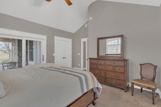 bedroom with high vaulted ceiling, multiple windows, a ceiling fan, and light carpet