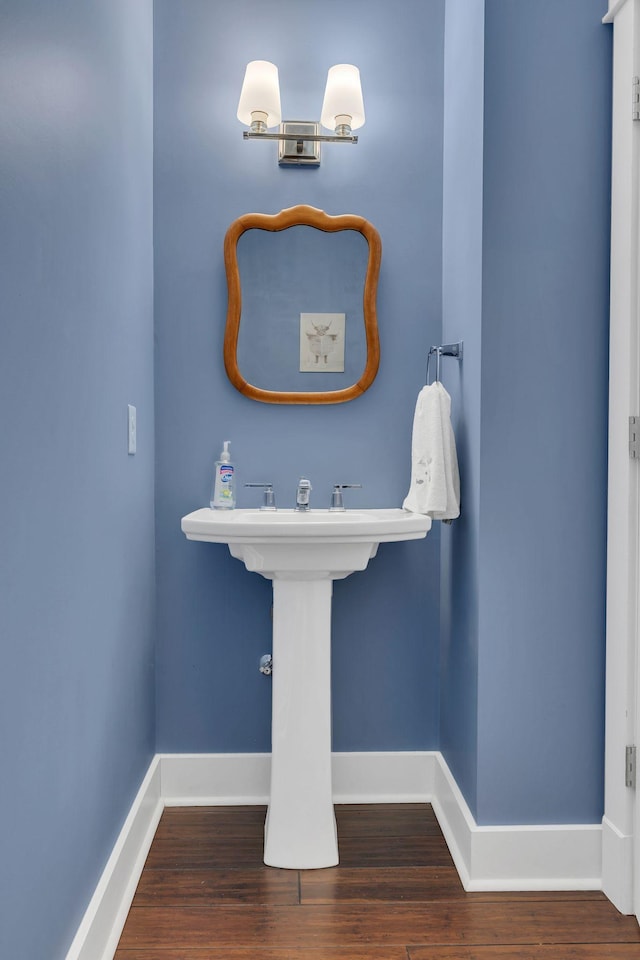 bathroom with baseboards and wood finished floors