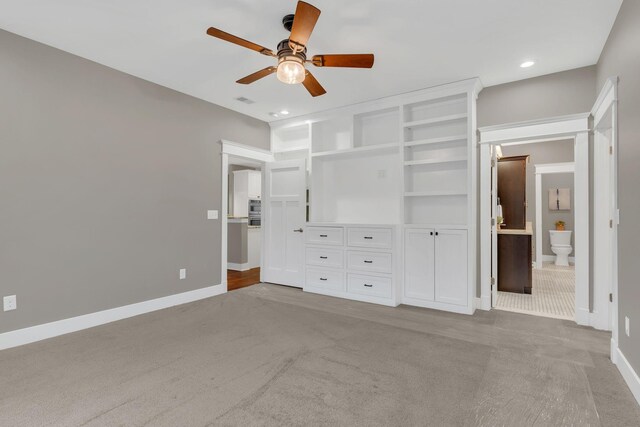 unfurnished bedroom with visible vents, carpet, baseboards, and ensuite bathroom