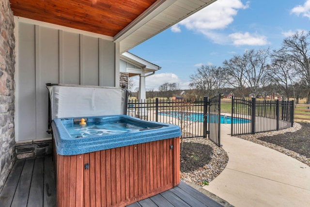 wooden terrace featuring a fenced in pool, fence, and a hot tub