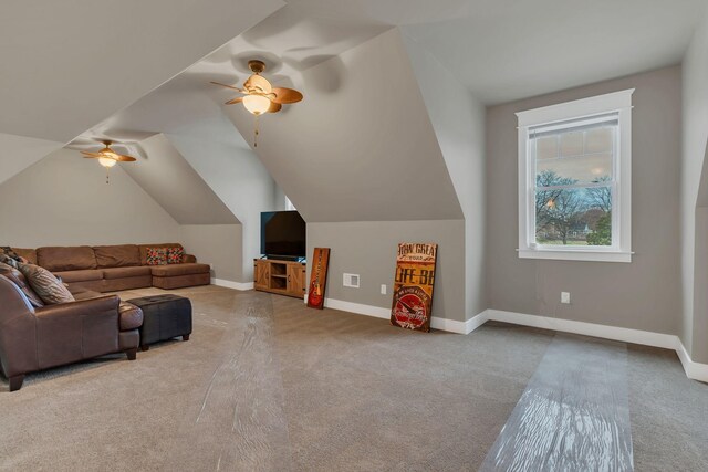 interior space featuring a ceiling fan, lofted ceiling, and baseboards