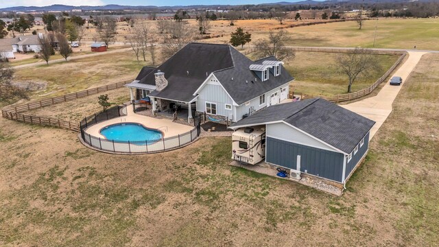 view of swimming pool featuring a rural view, a fenced in pool, fence, a mountain view, and a patio