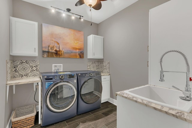 washroom featuring a ceiling fan, wood finish floors, cabinet space, a sink, and washer and clothes dryer