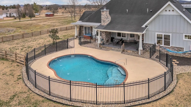 view of pool with a patio area, a fenced in pool, and fence private yard