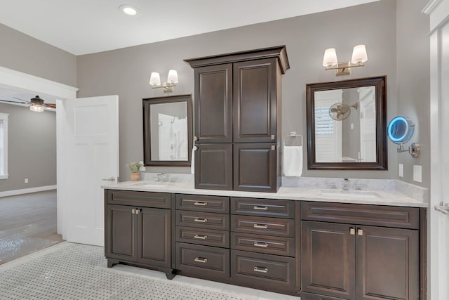 bathroom with double vanity, tile patterned floors, ceiling fan, and a sink