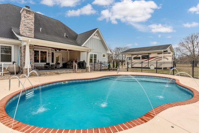 view of pool featuring a patio area, a fenced backyard, a fenced in pool, and a ceiling fan