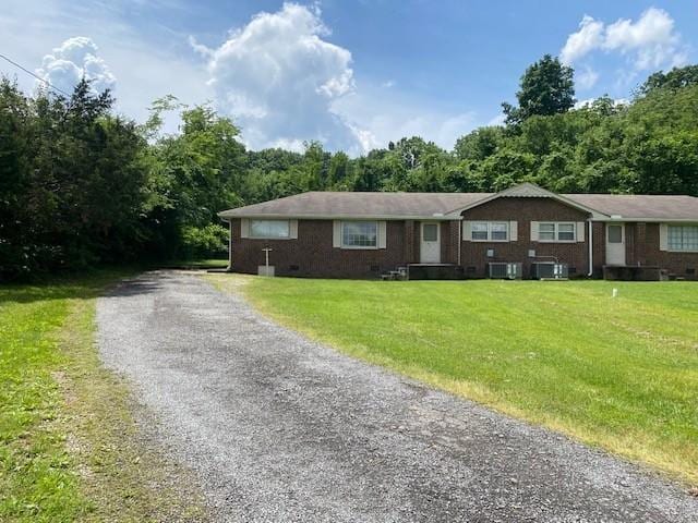 single story home with aphalt driveway, cooling unit, a front yard, and crawl space