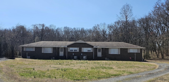 ranch-style home with a front yard, central air condition unit, brick siding, and crawl space