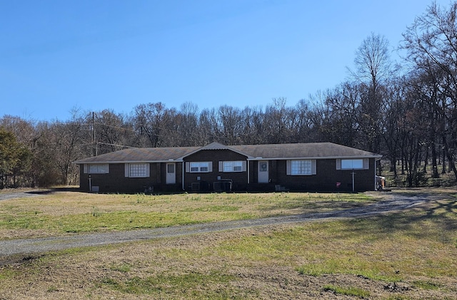 view of front facade with brick siding and a front yard