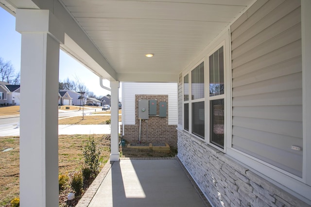 view of patio featuring covered porch and a residential view