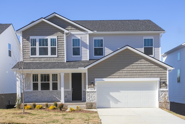 craftsman house featuring a porch, concrete driveway, stone siding, and roof with shingles