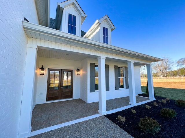 entrance to property with brick siding and french doors