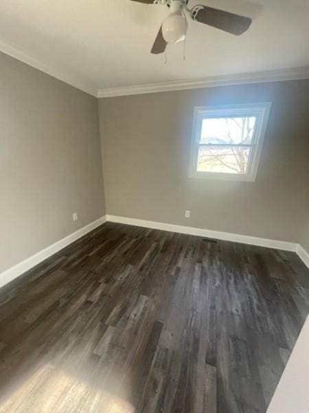 spare room featuring ceiling fan, dark wood-type flooring, baseboards, and ornamental molding