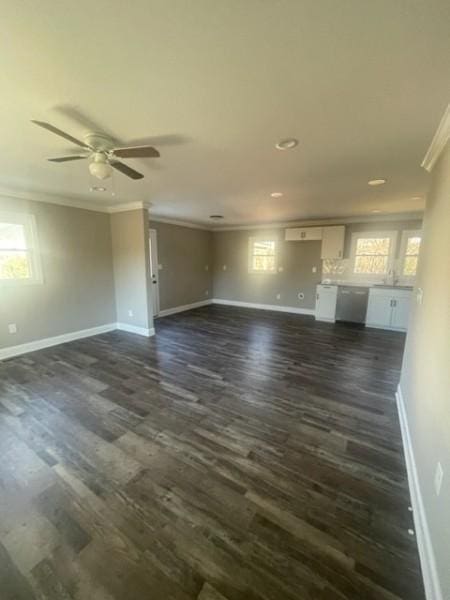 unfurnished living room with ceiling fan, baseboards, dark wood-style flooring, and crown molding