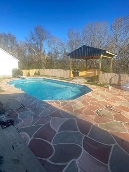 view of pool with a fenced in pool, a fenced backyard, and a patio area