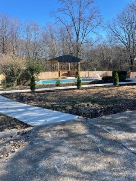 view of yard with a swimming pool and fence