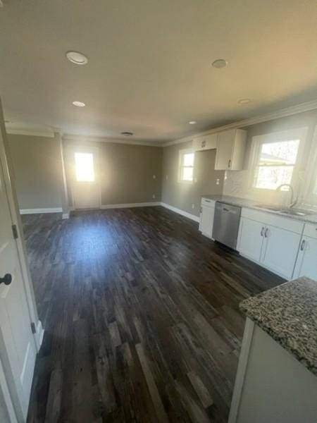 kitchen featuring ornamental molding, dark wood finished floors, white cabinets, baseboards, and dishwasher