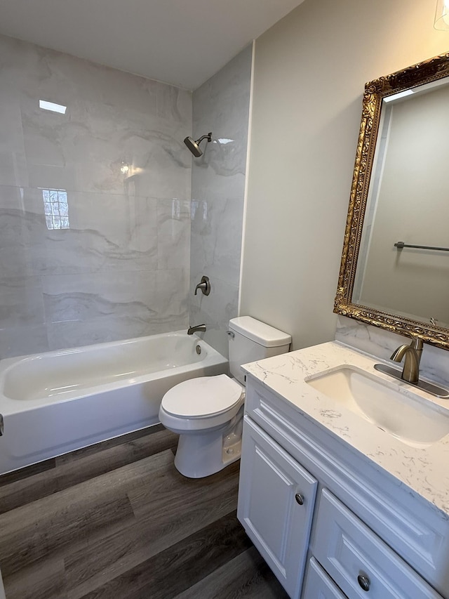 full bathroom featuring vanity, toilet, shower / bathtub combination, and wood finished floors