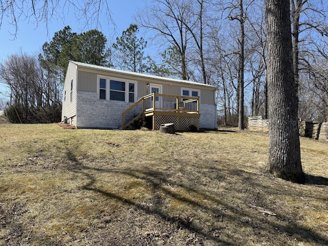 view of front of property with a deck and brick siding