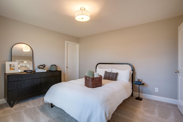 bedroom with baseboards and light colored carpet