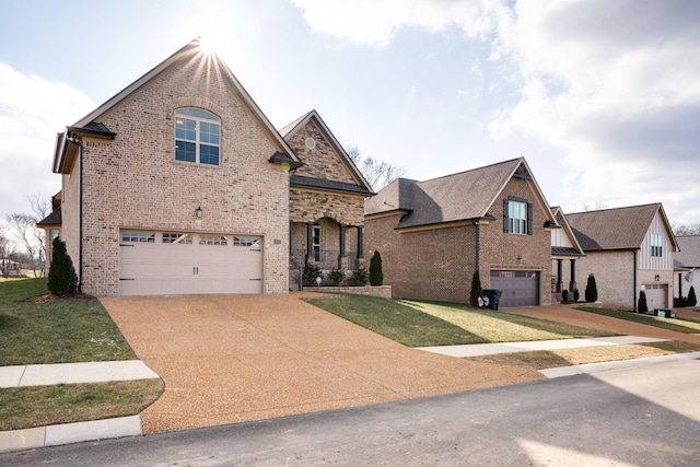 view of front facade with brick siding, a front lawn, concrete driveway, and a garage