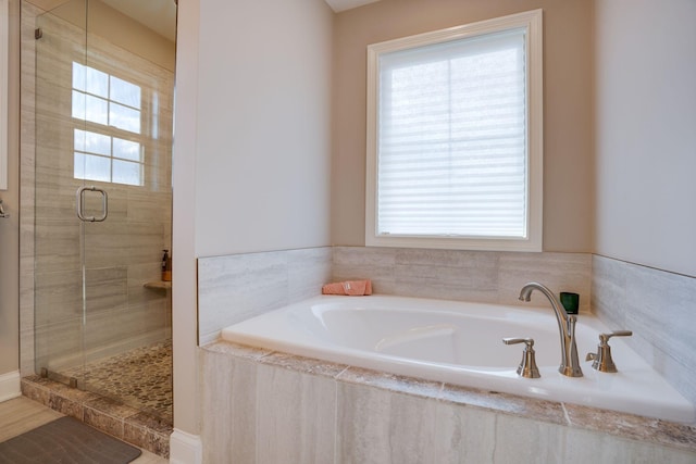 bathroom with a garden tub and a stall shower