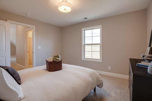 bedroom with baseboards and light colored carpet