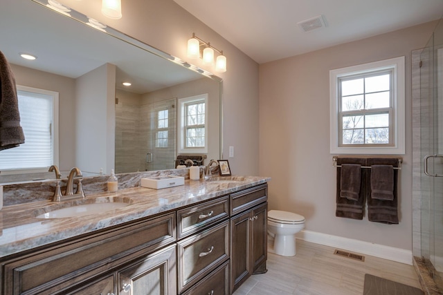 full bathroom with a sink, visible vents, baseboards, and a stall shower