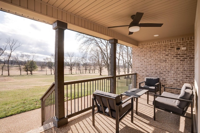 wooden deck with outdoor lounge area, a yard, and ceiling fan