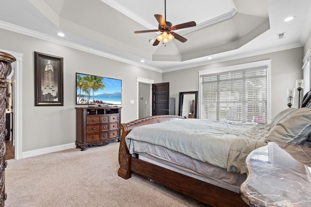 bedroom with baseboards, visible vents, a tray ceiling, light carpet, and crown molding