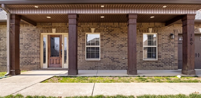 doorway to property with brick siding