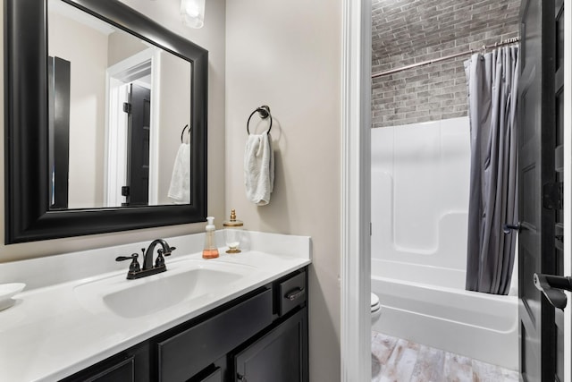 full bathroom featuring toilet, wood finished floors, vanity, and shower / bath combination with curtain