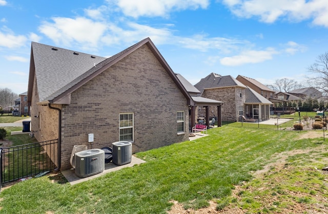 view of property exterior with cooling unit, a patio, brick siding, and a lawn