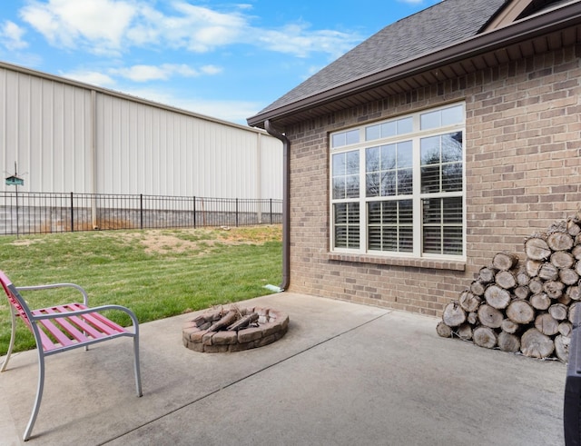 view of patio featuring an outdoor fire pit and fence