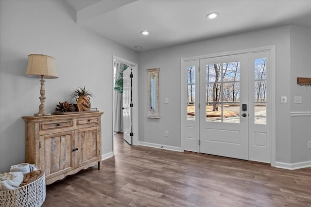 entryway with dark wood finished floors, recessed lighting, and baseboards