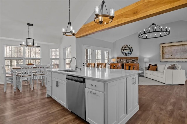 kitchen featuring dark wood finished floors, dishwasher, light countertops, a notable chandelier, and a sink