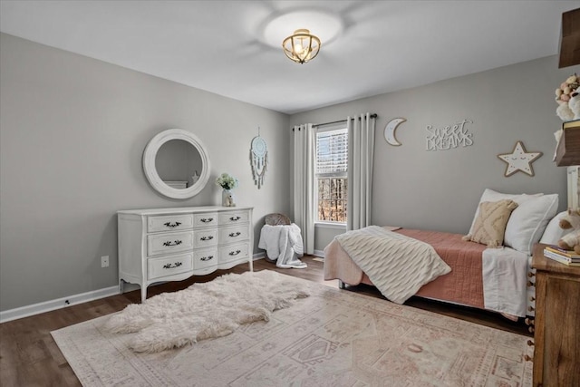 bedroom with wood finished floors and baseboards